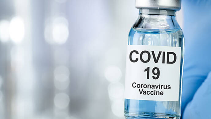 a doctor handling a bottle of COVID19 vaccine