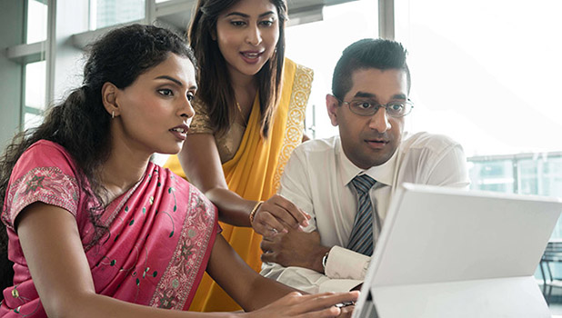 Indian people working together in front of a computer - kzenon - adobe stock