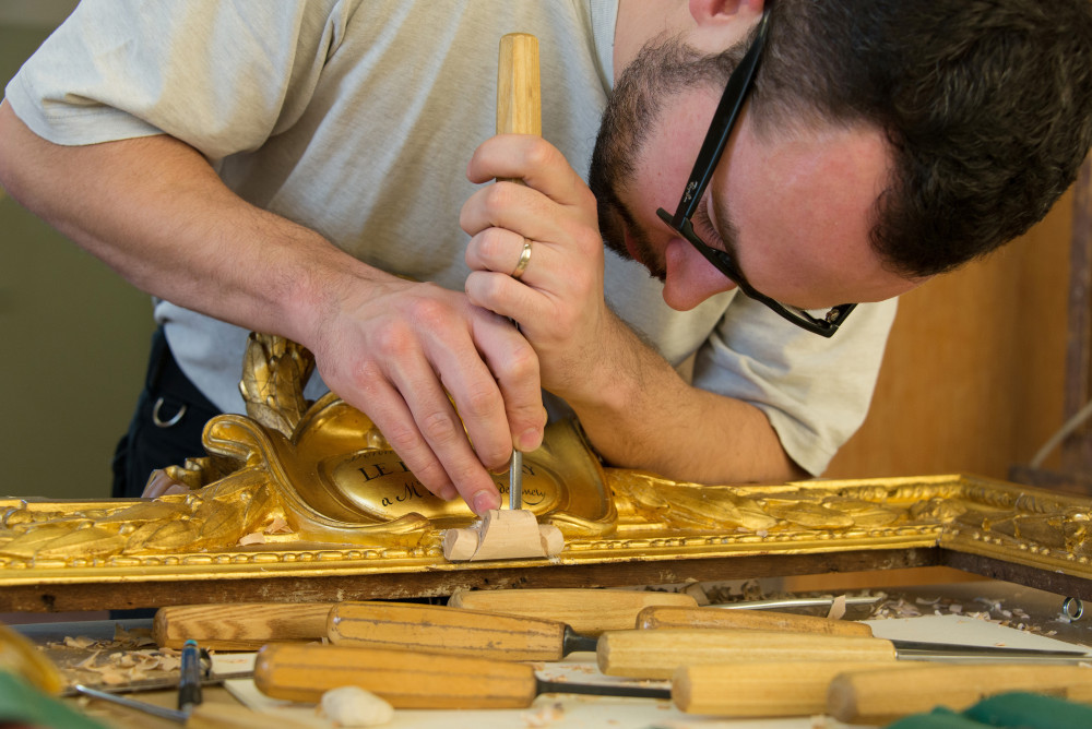 Student working on gold frame