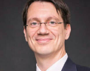 Photo headshot of Ioanid Rosu, professor of Finance