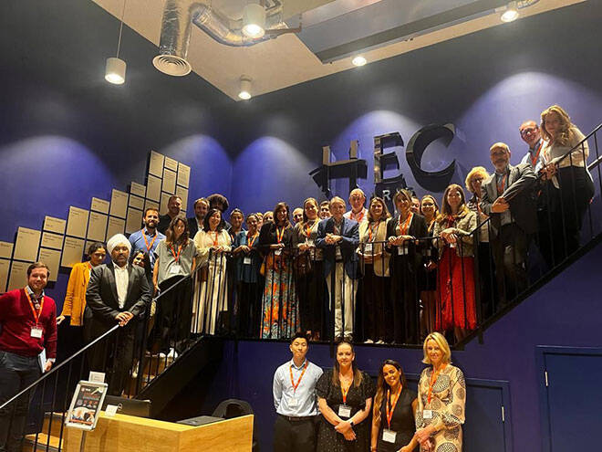 Iventiv event participants at HEC London standing on a staircase, posing for a photo.